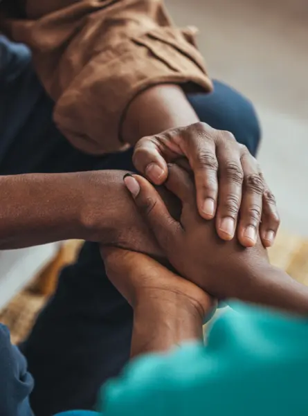 Closeup of a support hands. Closeup shot of a young woman holding a senior man's hands