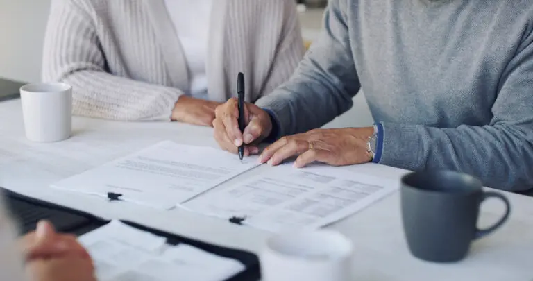 Older woman signing estate planning documents